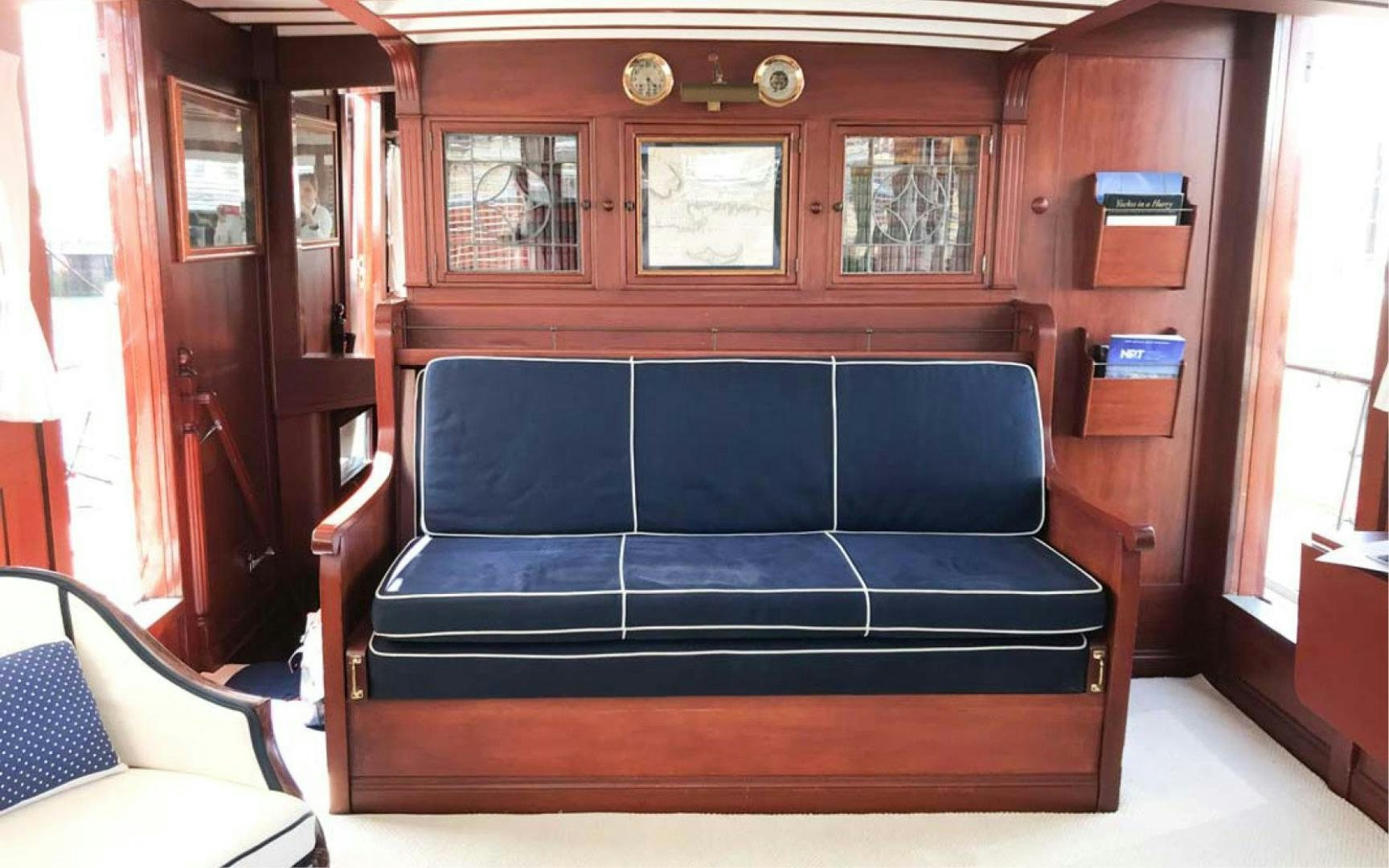a blue couch in a cabin aboard SCOUT Yacht for Sale