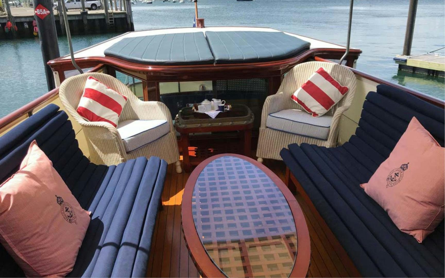 a boat with pillows and chairs on a dock aboard SCOUT Yacht for Sale