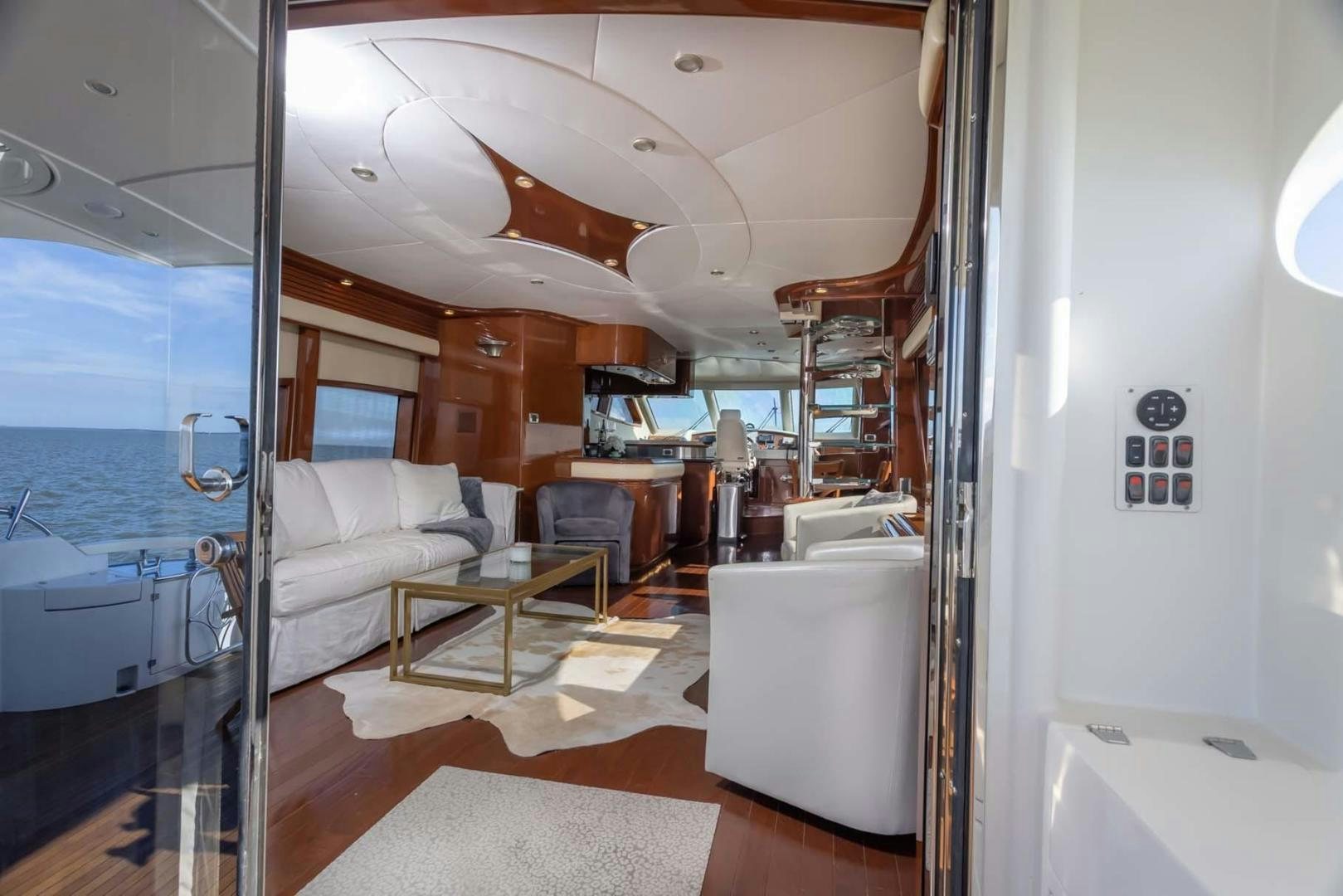 a living room with a glass door aboard DECKED OUT Yacht for Sale
