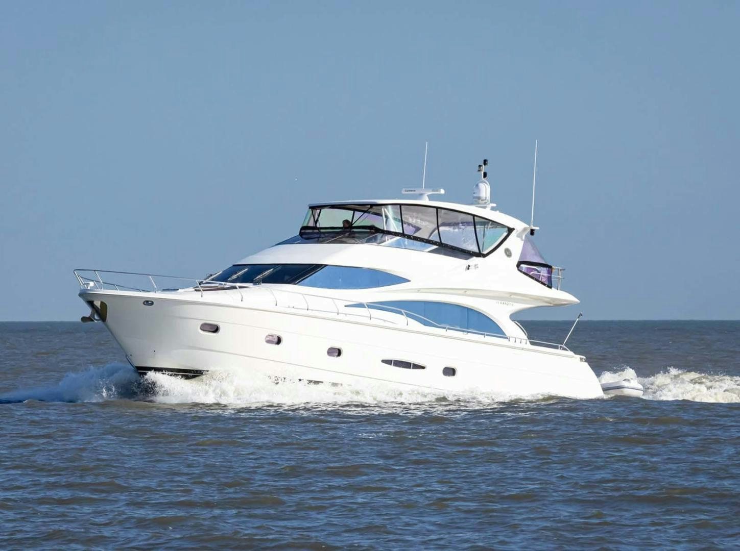 a white yacht in the water aboard DECKED OUT Yacht for Sale