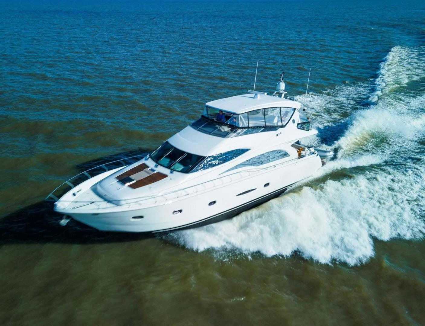 a white boat on the water aboard DECKED OUT Yacht for Sale