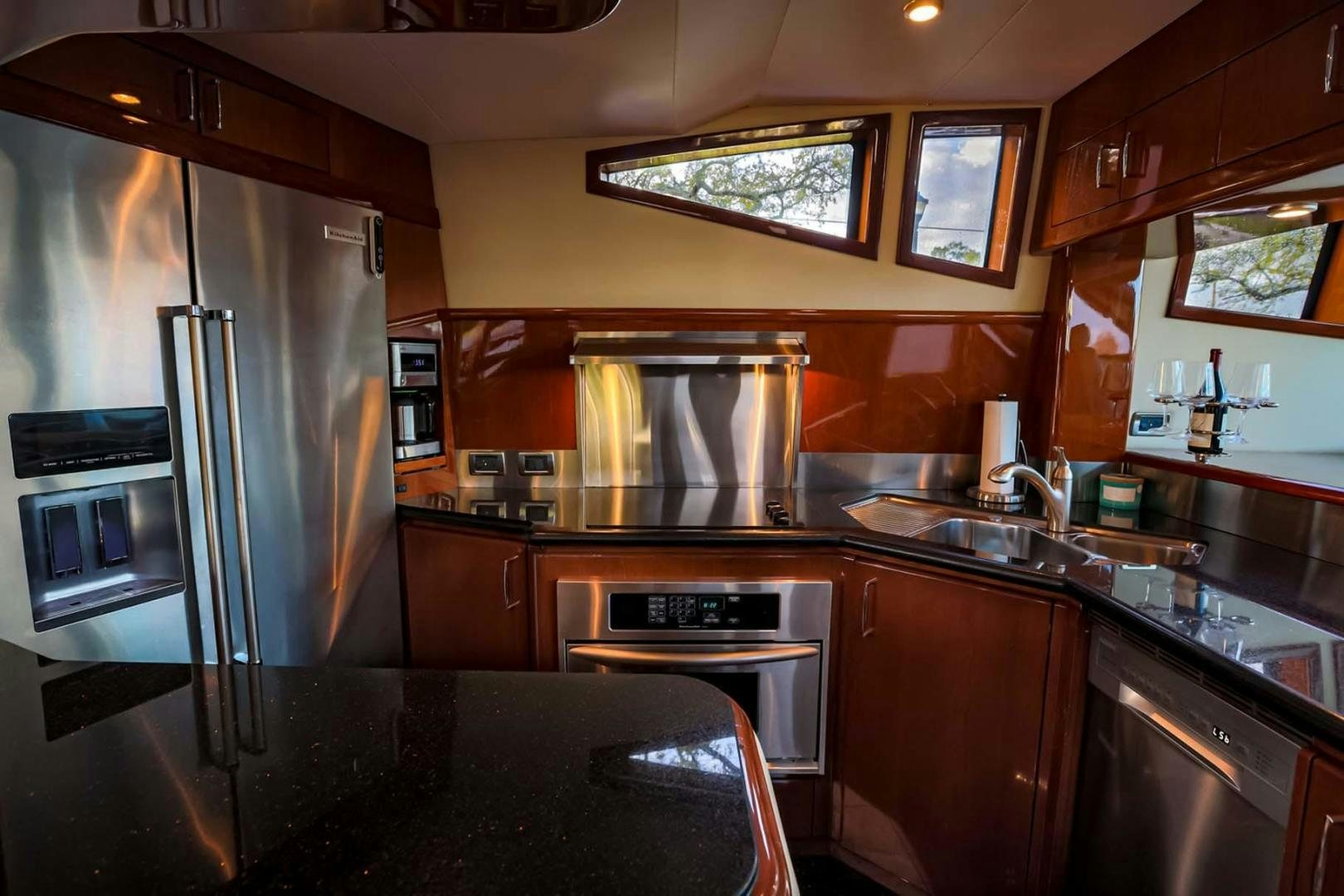 a kitchen with a stainless steel refrigerator aboard DECKED OUT Yacht for Sale