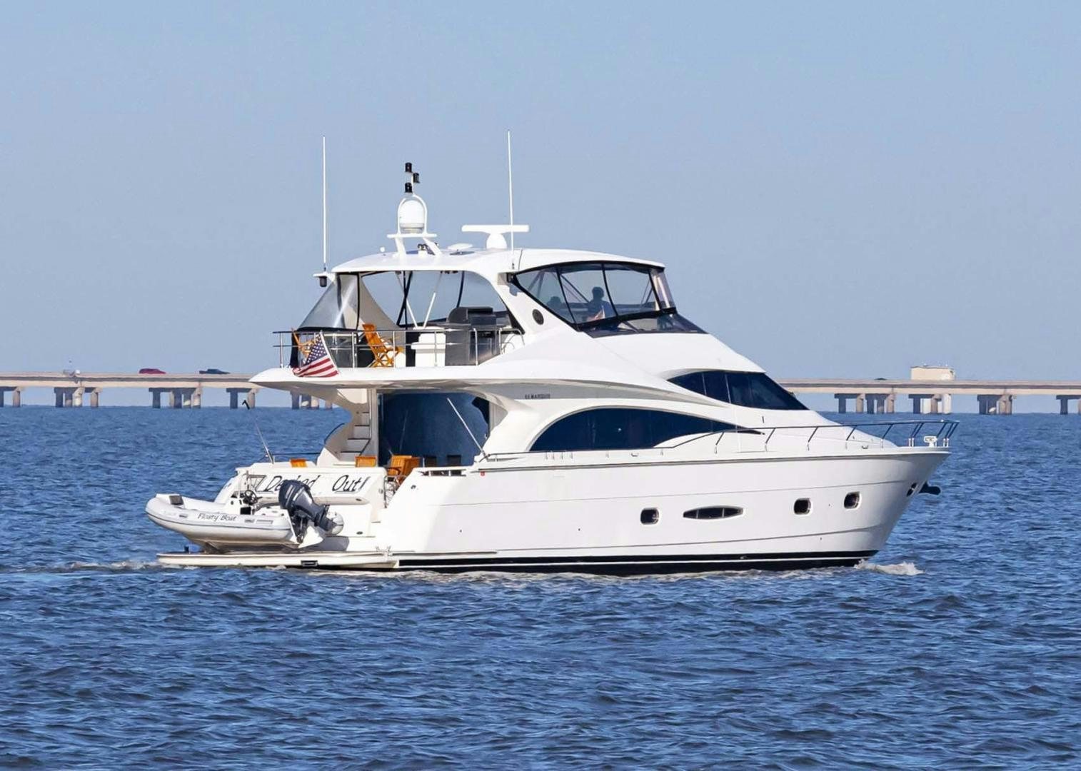 a white yacht in the water aboard DECKED OUT Yacht for Sale