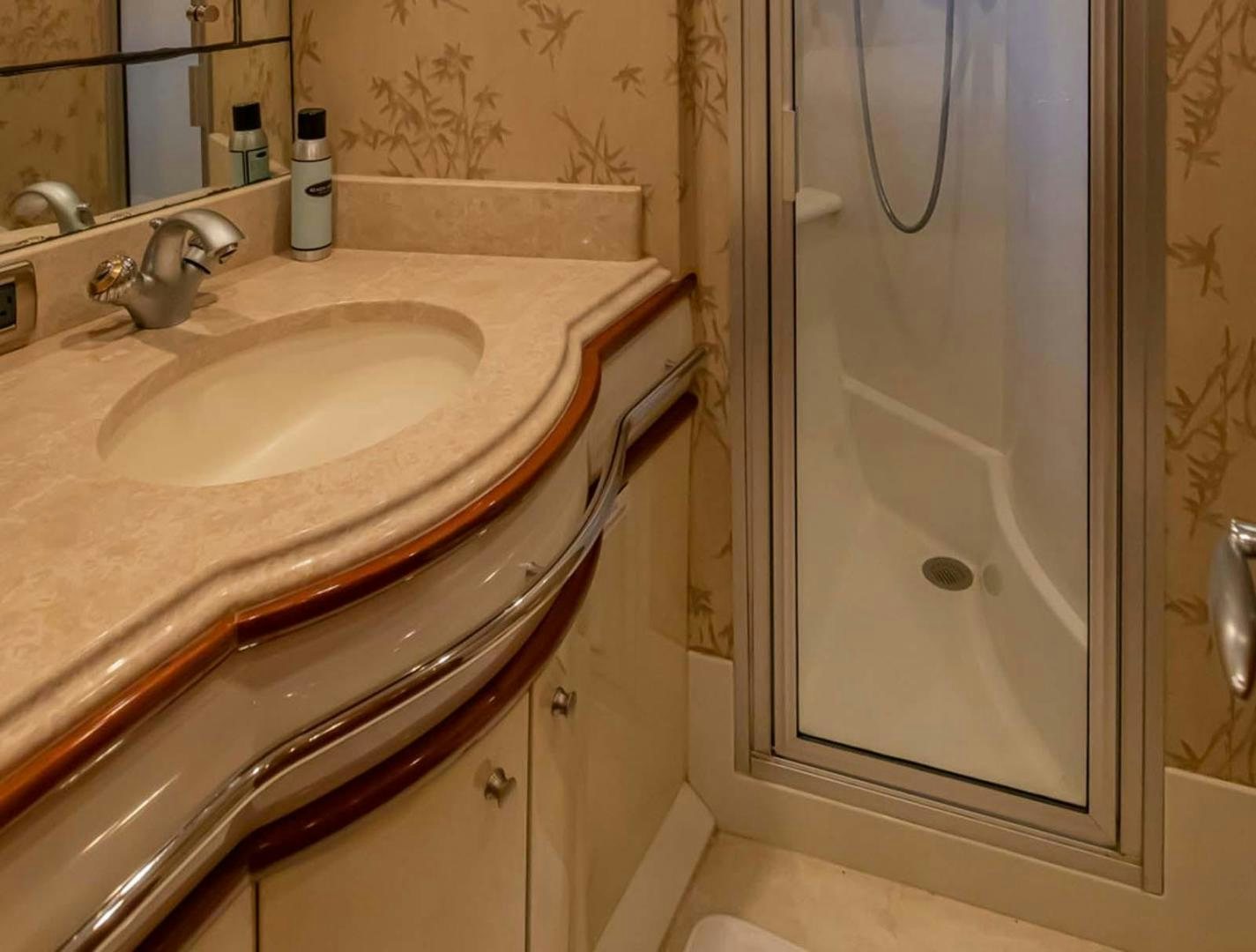 a bathroom with a sink and a mirror aboard DECKED OUT Yacht for Sale