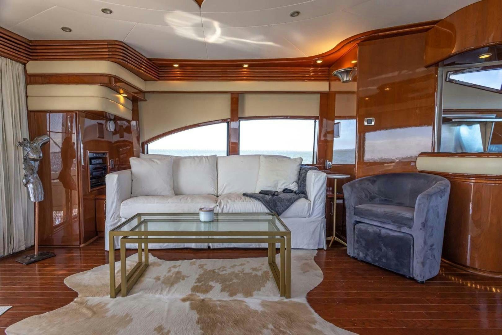 a living room with a couch and a table aboard DECKED OUT Yacht for Sale