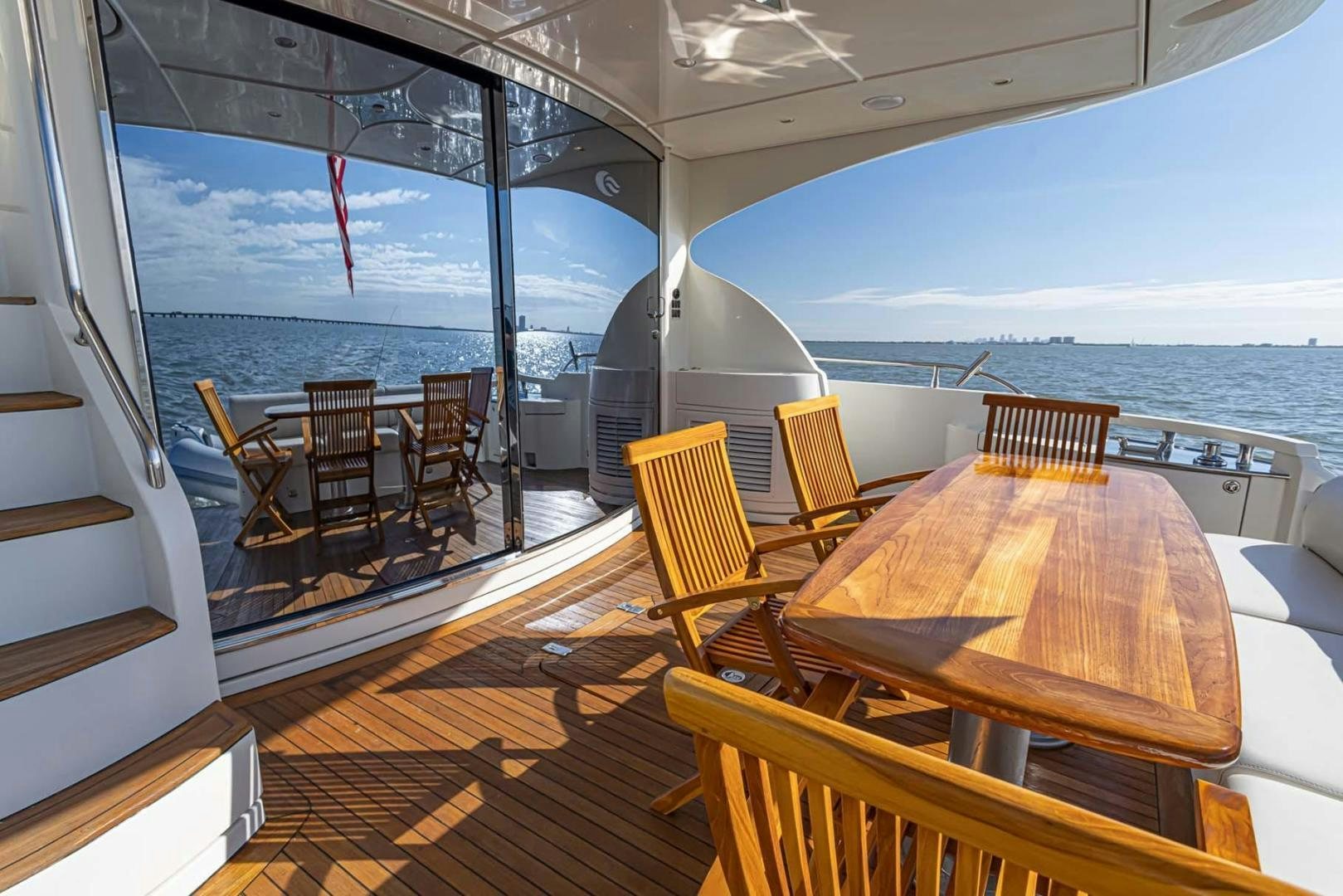 a deck with a view of the ocean and the ocean aboard DECKED OUT Yacht for Sale