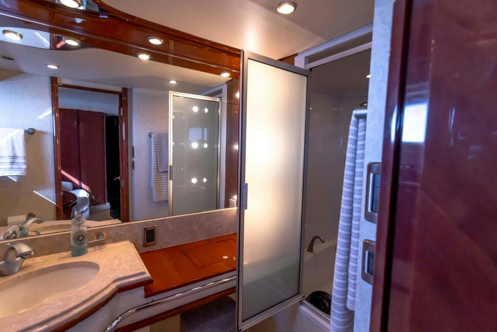 a bathroom with a large mirror aboard DECKED OUT Yacht for Sale