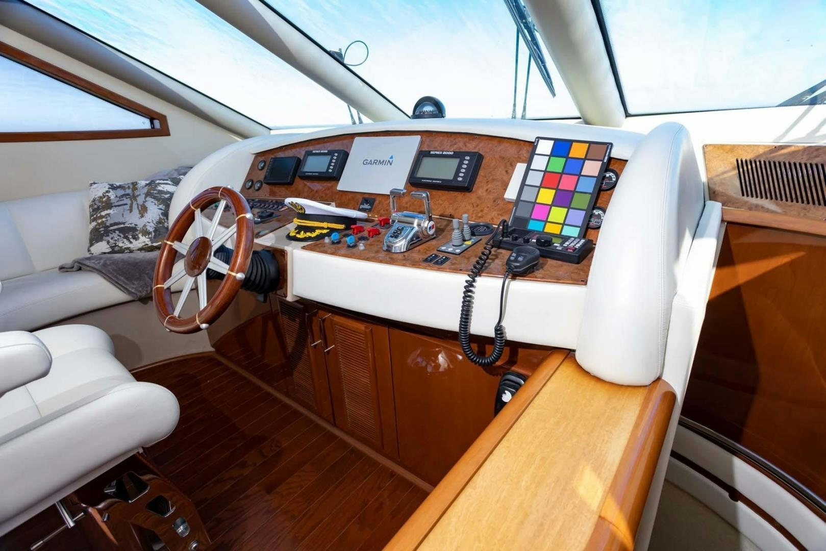 a table with a laptop and headphones on it aboard DECKED OUT Yacht for Sale