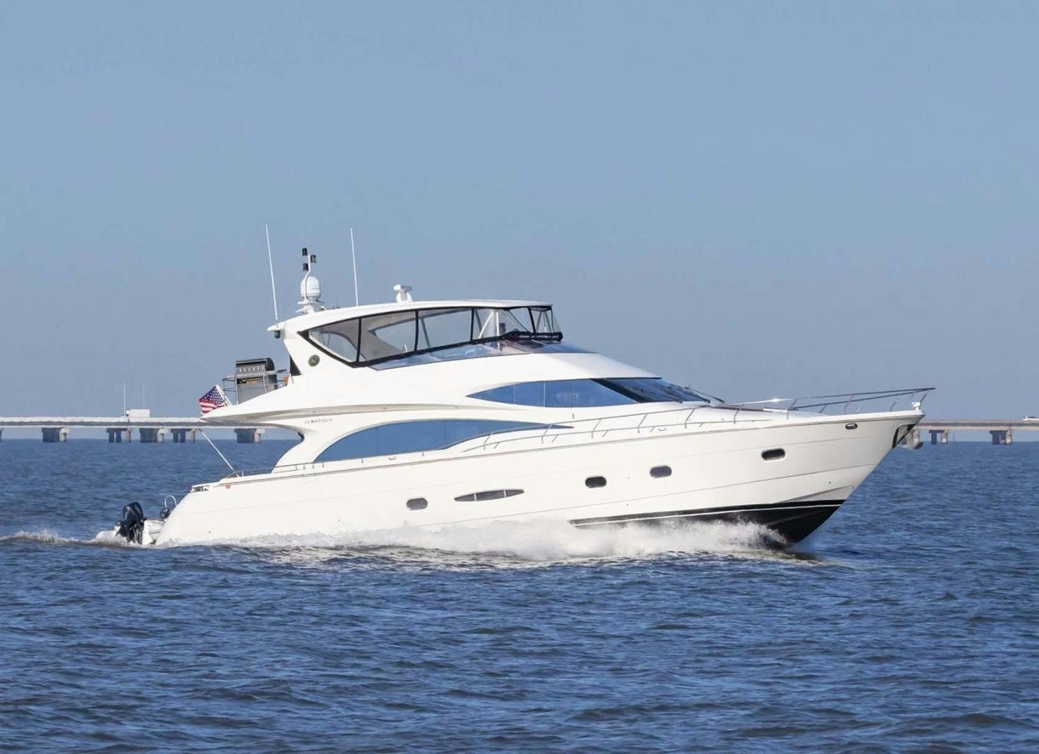a white yacht in the water aboard DECKED OUT Yacht for Sale