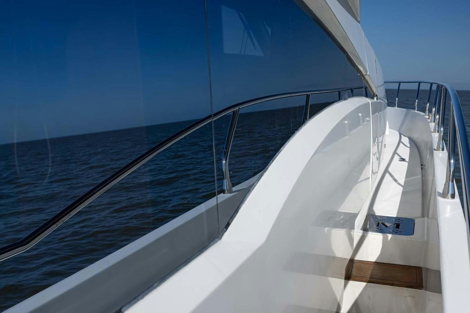 a white boat on a blue water aboard DECKED OUT Yacht for Sale