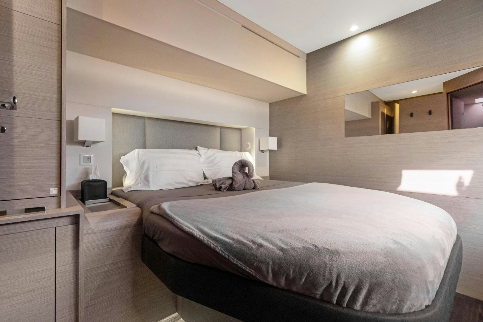 a dog lays on a bed aboard Ocean Seven Yacht for Sale