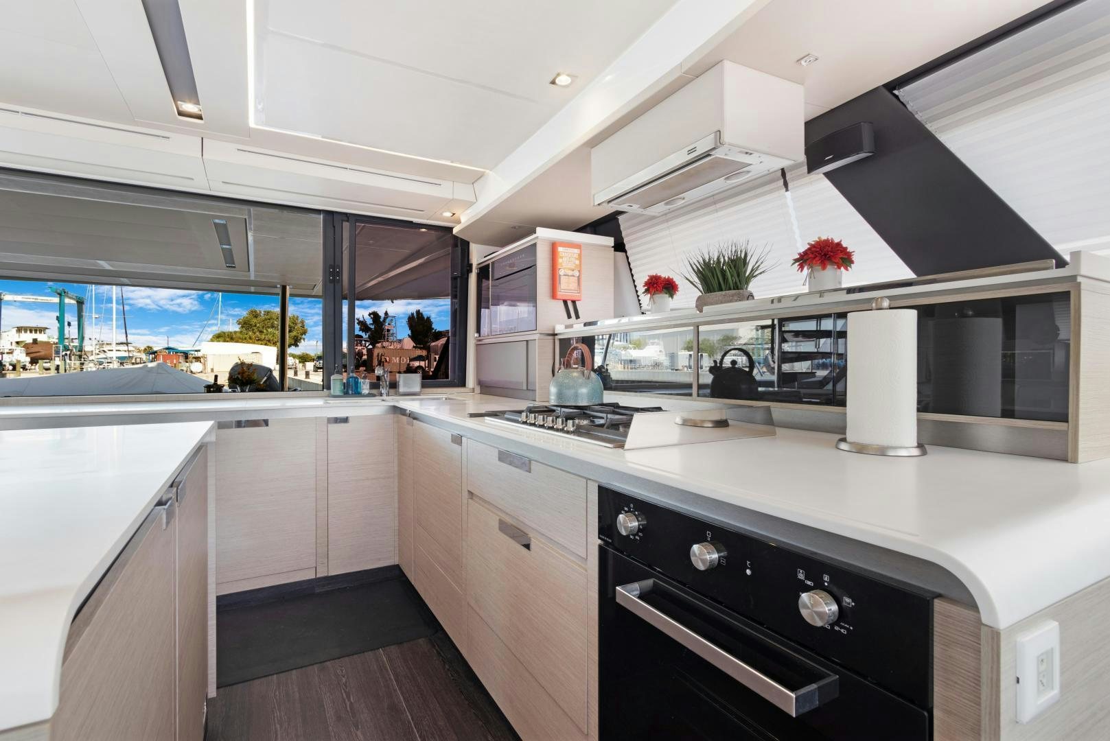 a kitchen with white cabinets aboard Ocean Seven Yacht for Sale