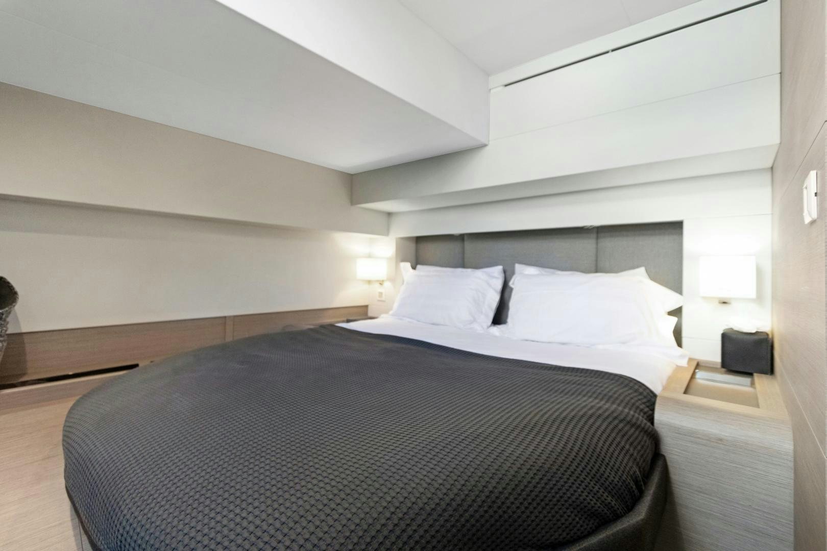 a bed with white sheets aboard Ocean Seven Yacht for Sale