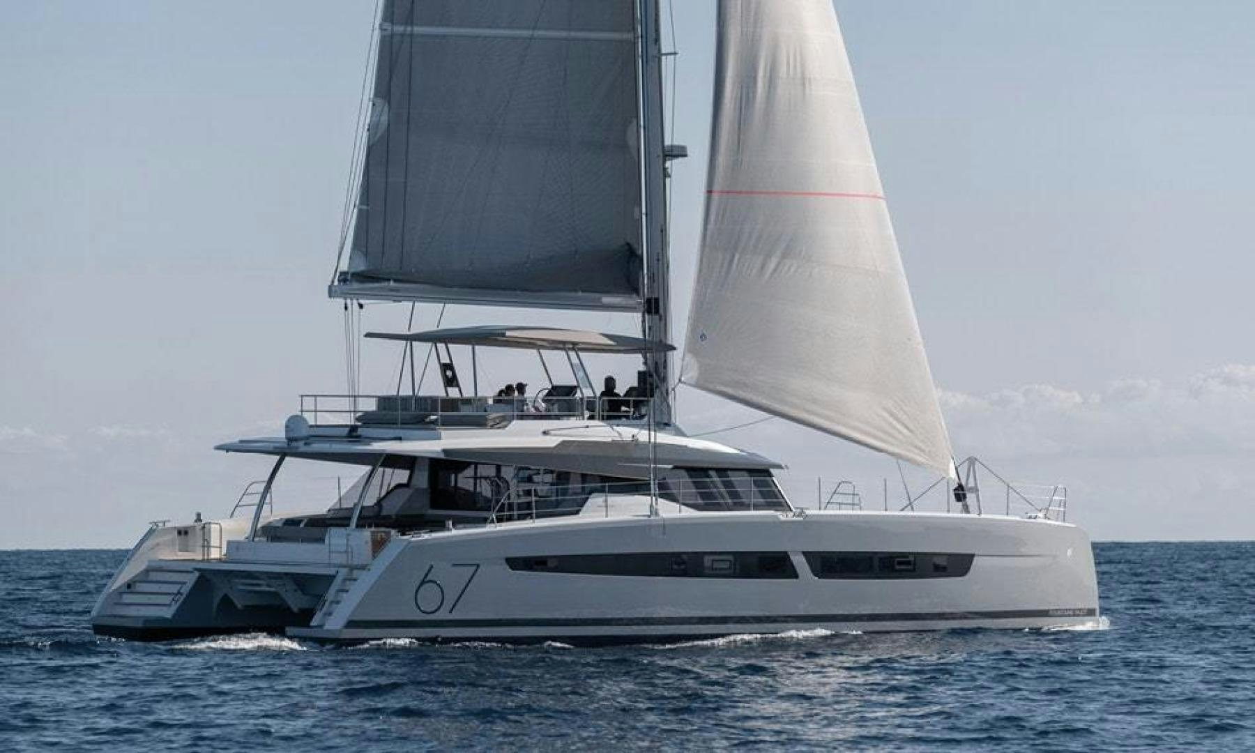 a white yacht in the water aboard Ocean Seven Yacht for Sale