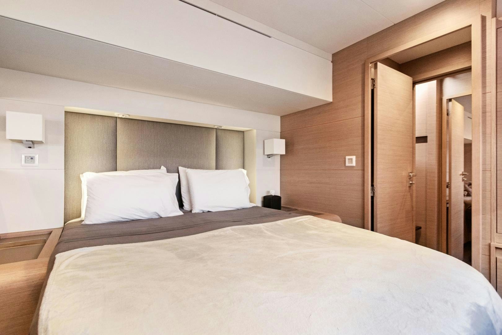 a large bed in a hotel room aboard Ocean Seven Yacht for Sale