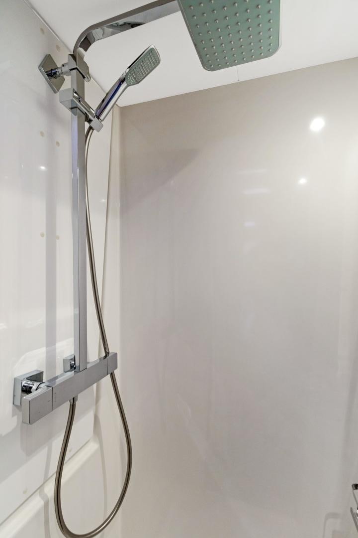 a shower with a glass wall aboard Ocean Seven Yacht for Sale