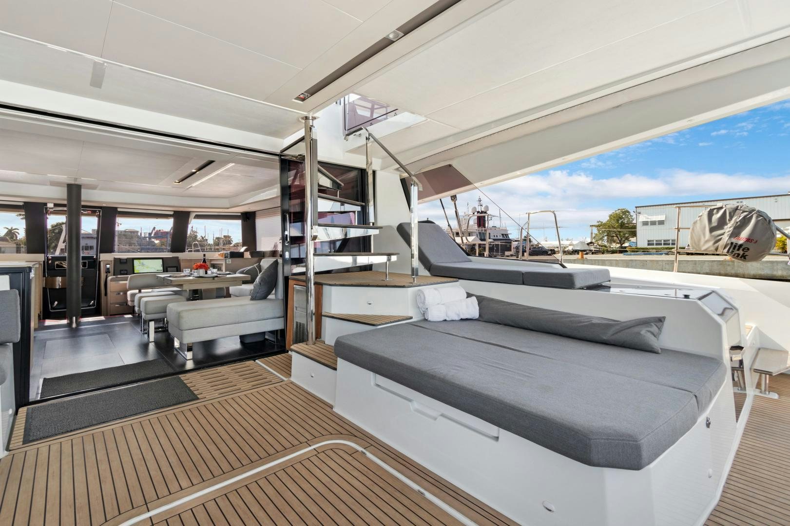 a room with a bed and a bench aboard Ocean Seven Yacht for Sale