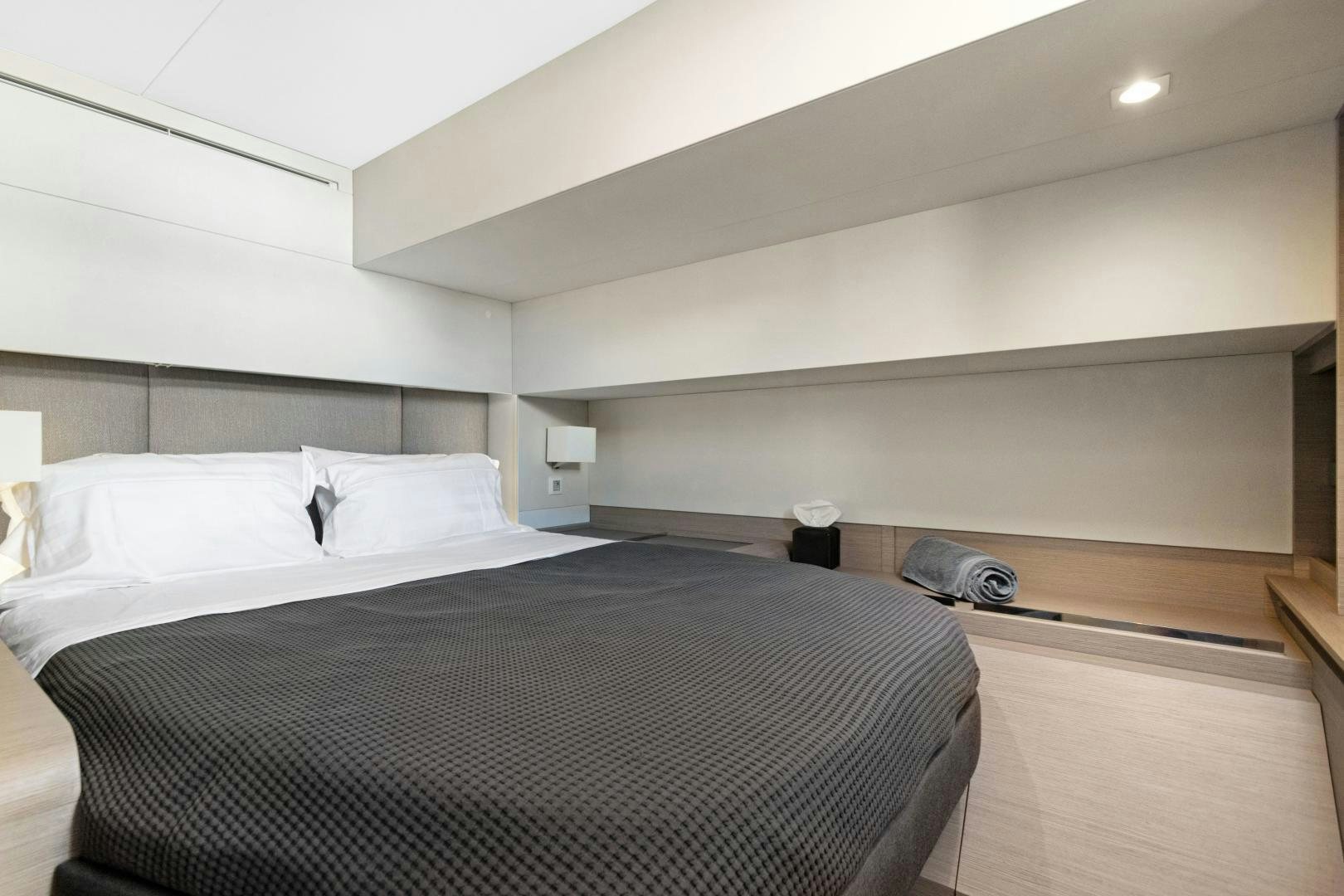 a bed with white sheets aboard Ocean Seven Yacht for Sale