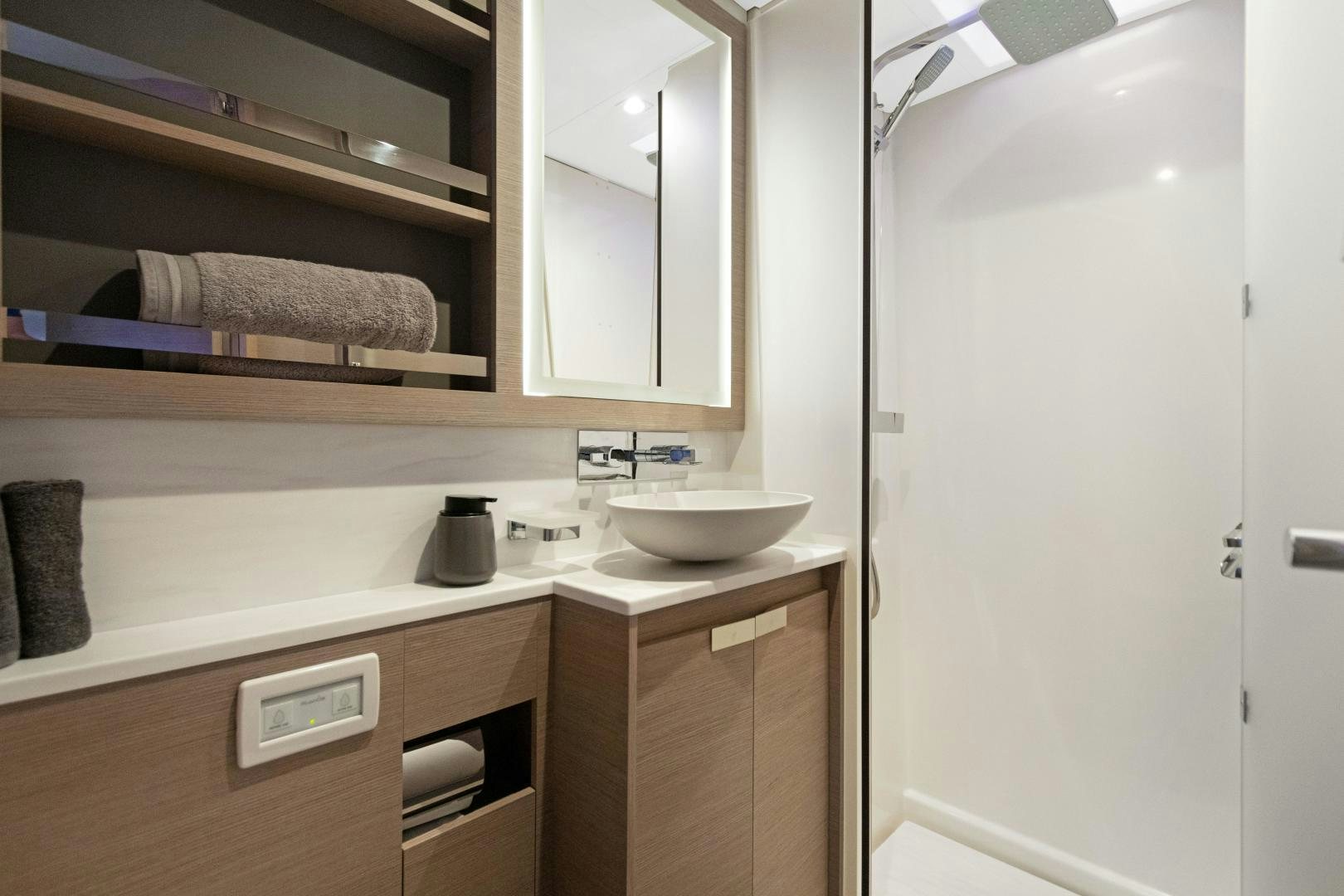 a sink and a mirror in a bathroom aboard Ocean Seven Yacht for Sale