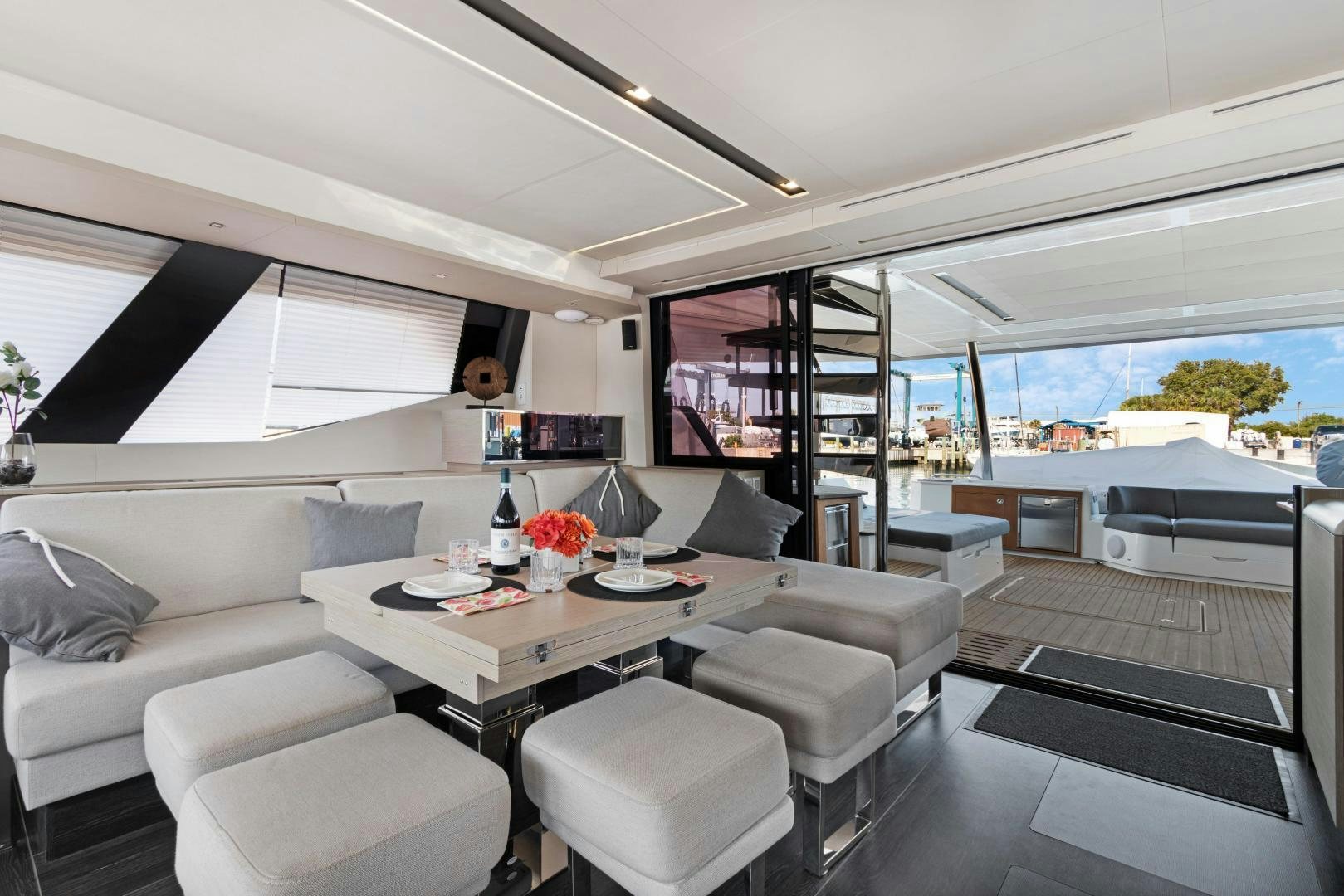 a living room with a large window aboard Ocean Seven Yacht for Sale