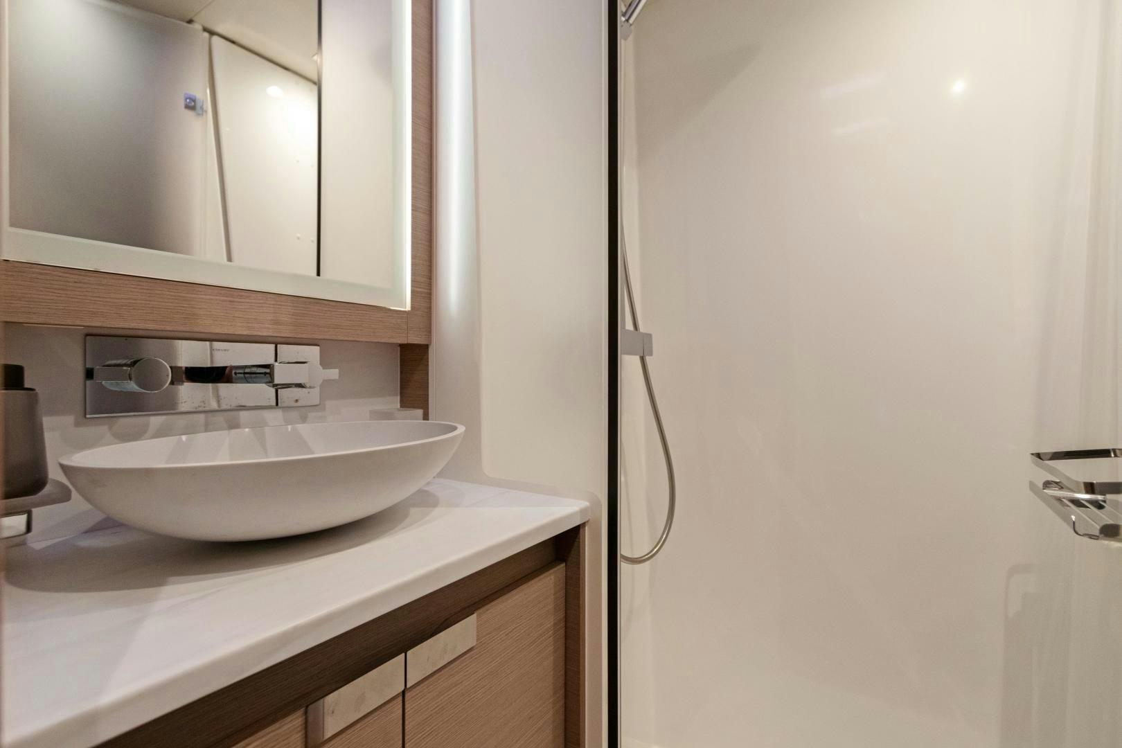a sink with a mirror aboard Ocean Seven Yacht for Sale