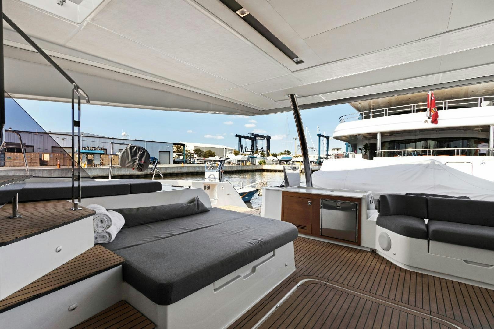 a boat with a deck and a deck with a deck and a view of the water aboard Ocean Seven Yacht for Sale