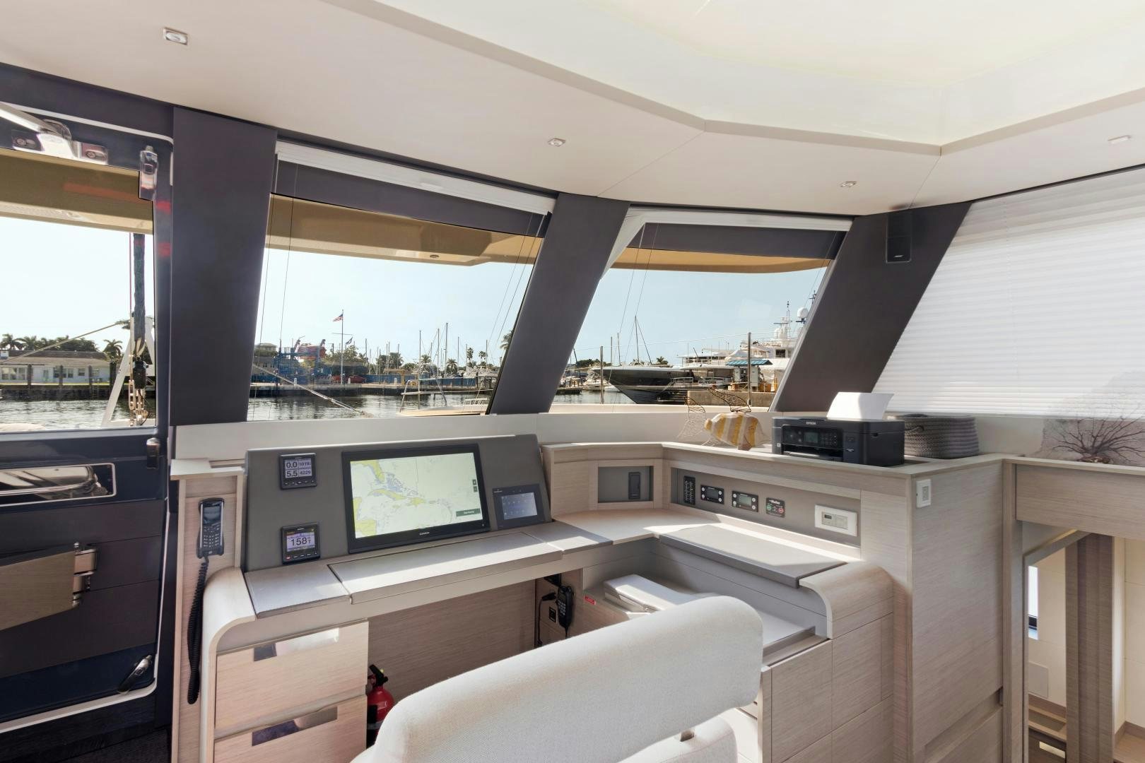 a vehicle with a desk and a computer on it aboard Ocean Seven Yacht for Sale