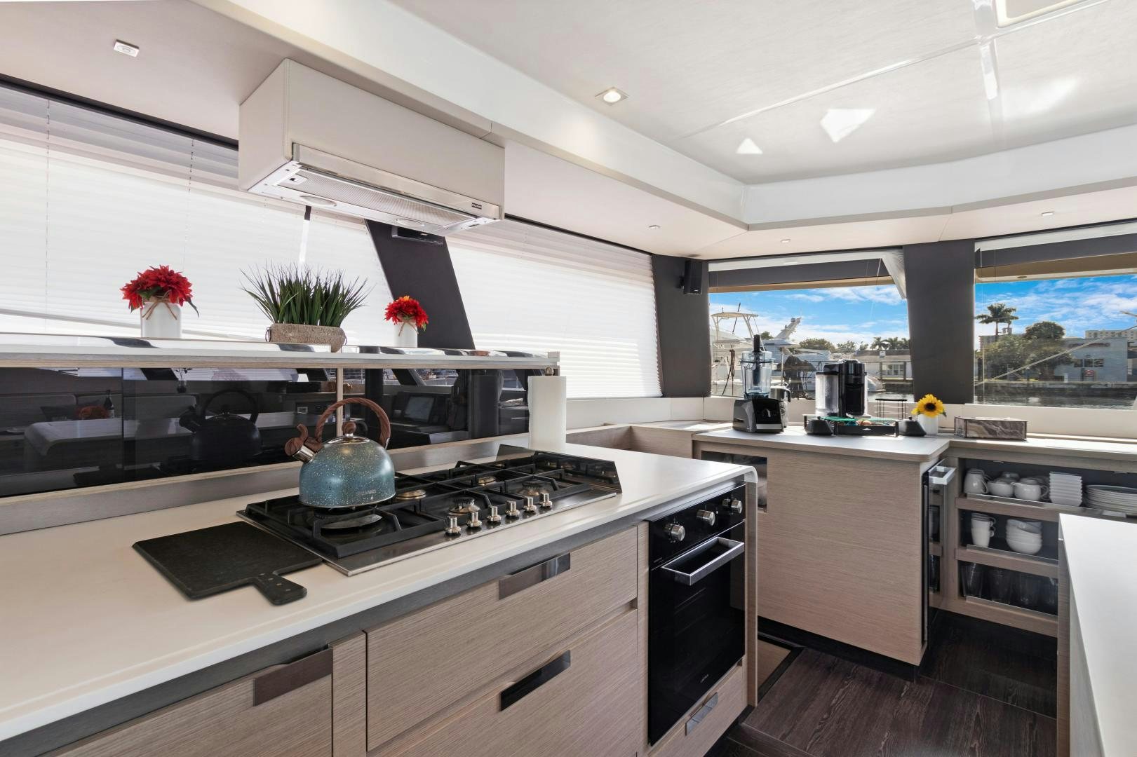 a kitchen with a stove and a potted plant aboard Ocean Seven Yacht for Sale
