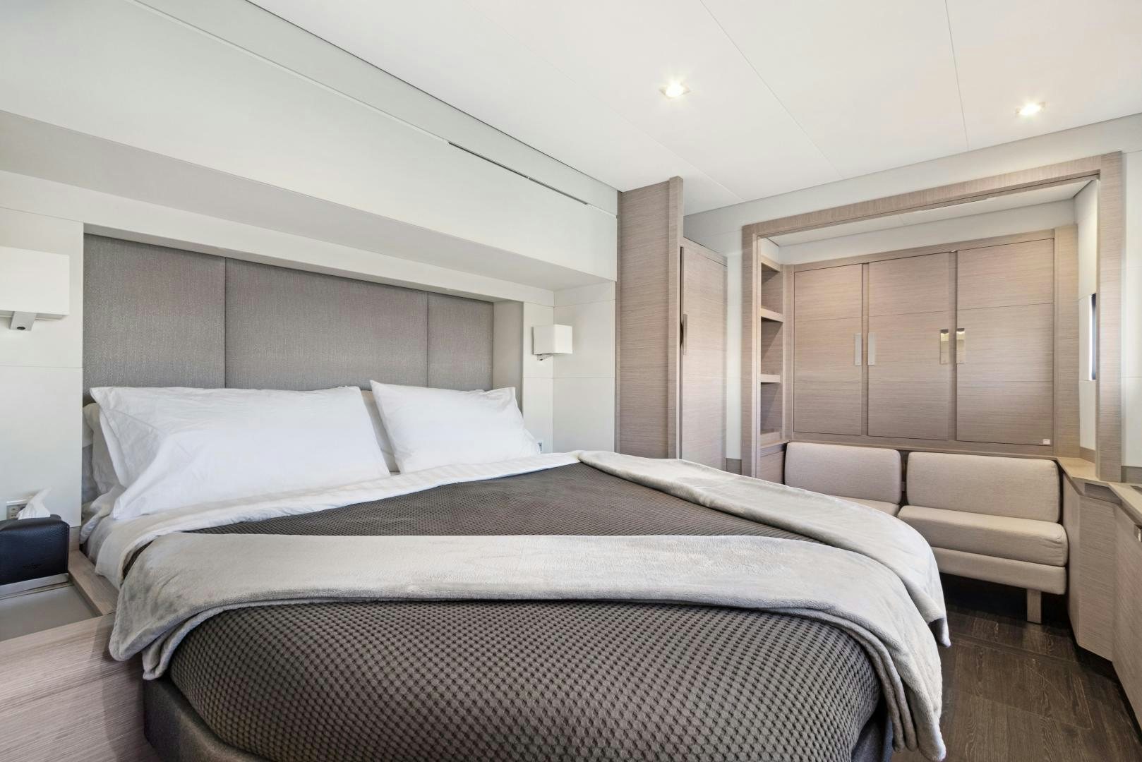 a room with a bed and a couch aboard Ocean Seven Yacht for Sale