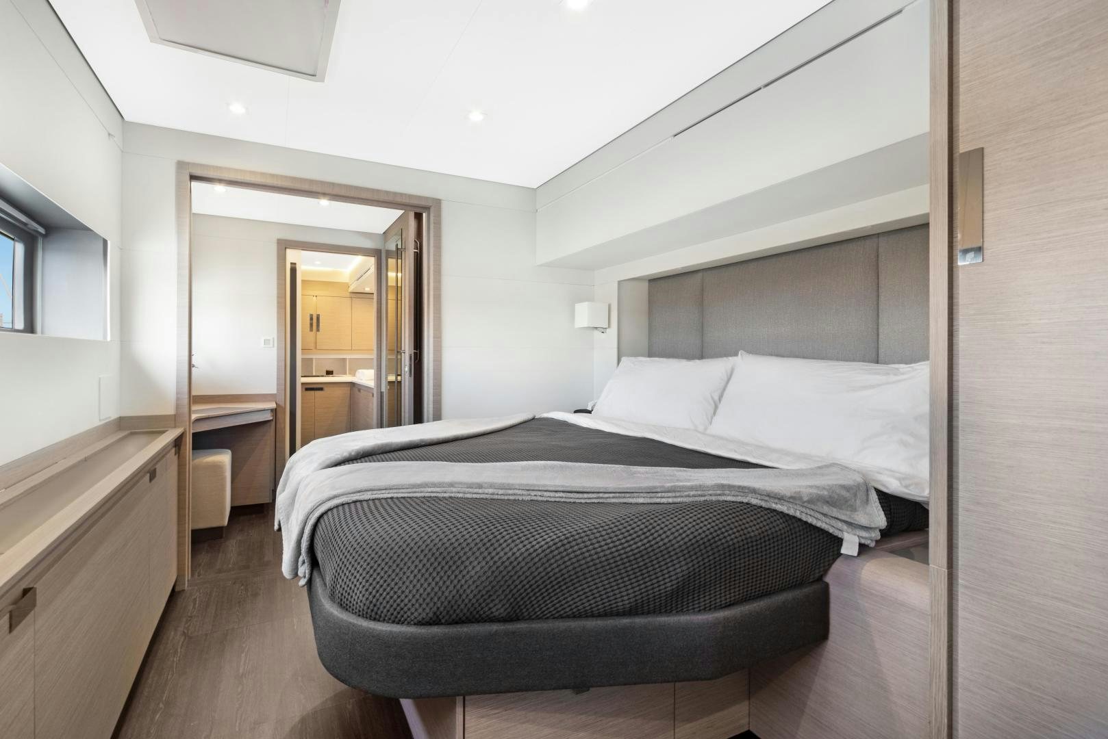 a bed in a room aboard Ocean Seven Yacht for Sale