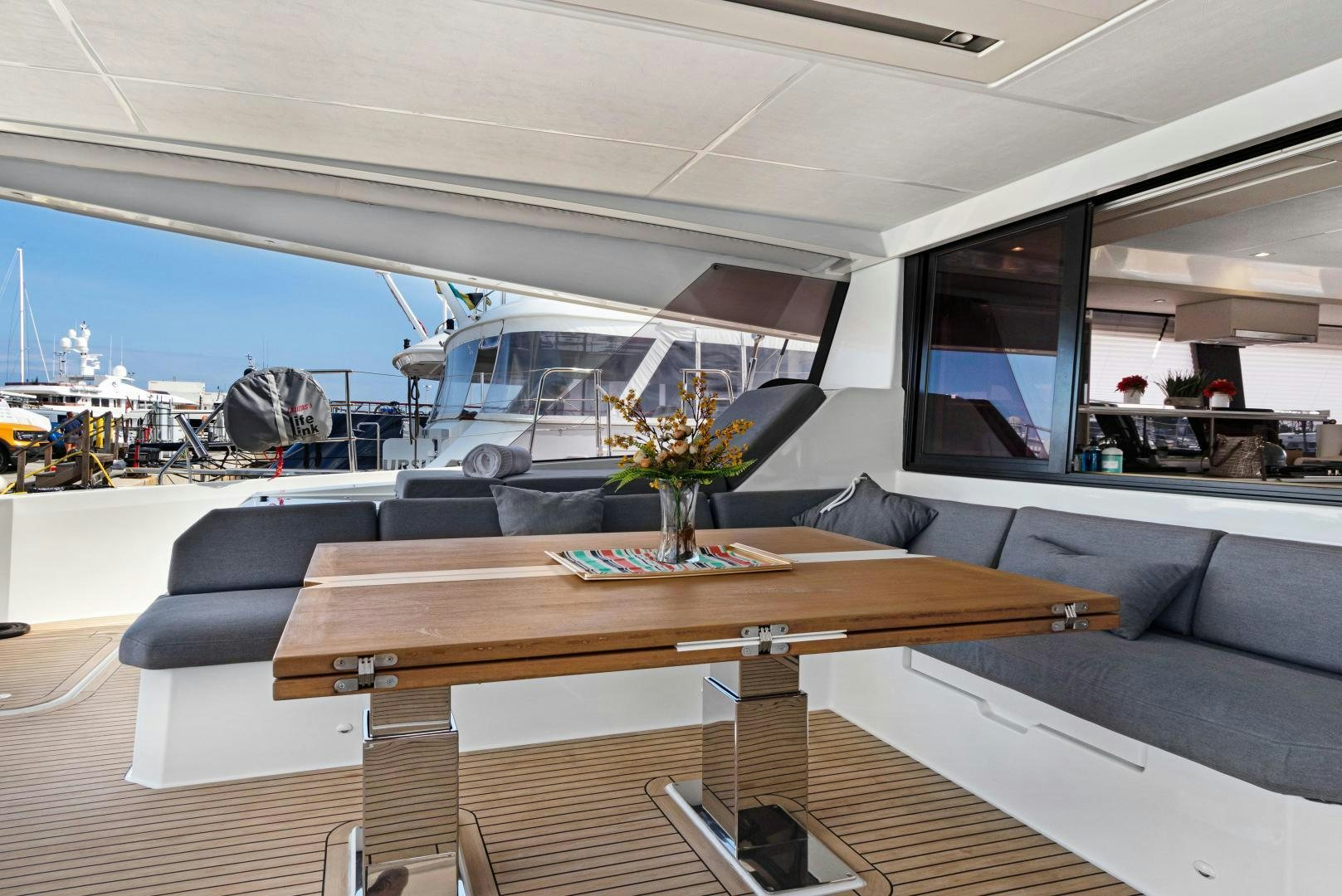 a room with a table and chairs aboard Ocean Seven Yacht for Sale