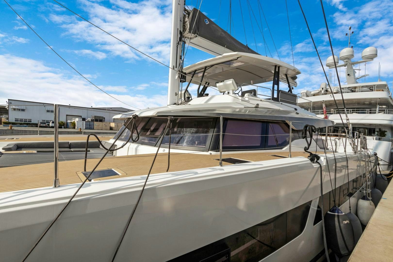 a white yacht in a dock aboard Ocean Seven Yacht for Sale