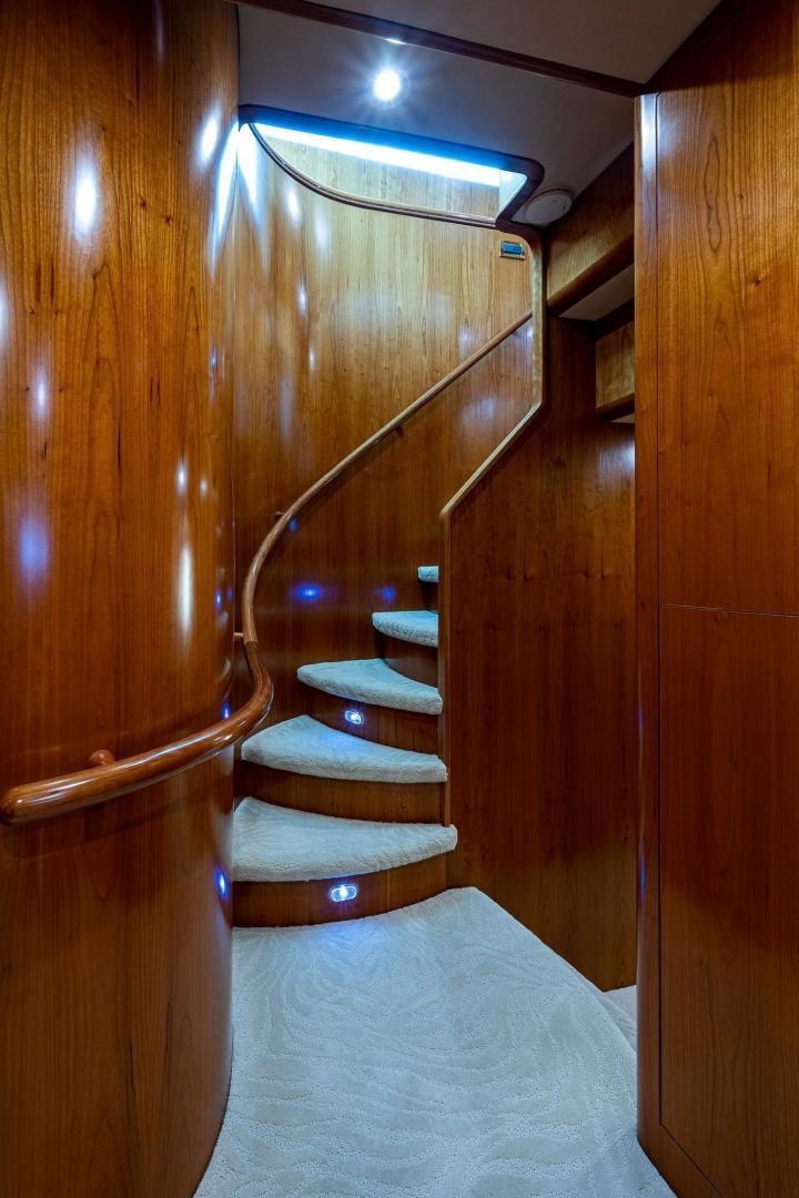 a staircase with a wood railing aboard ODYSSEY Yacht for Sale