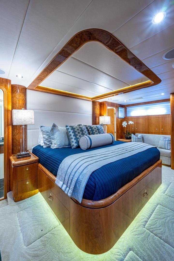 a bed with a blue comforter aboard ODYSSEY Yacht for Sale