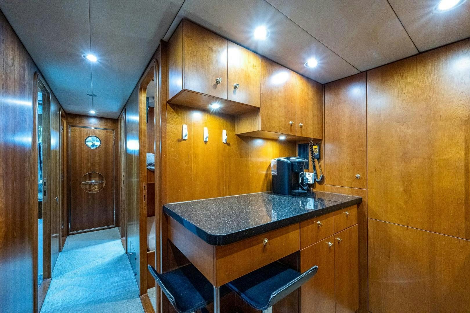 a kitchen with wooden cabinets aboard ODYSSEY Yacht for Sale