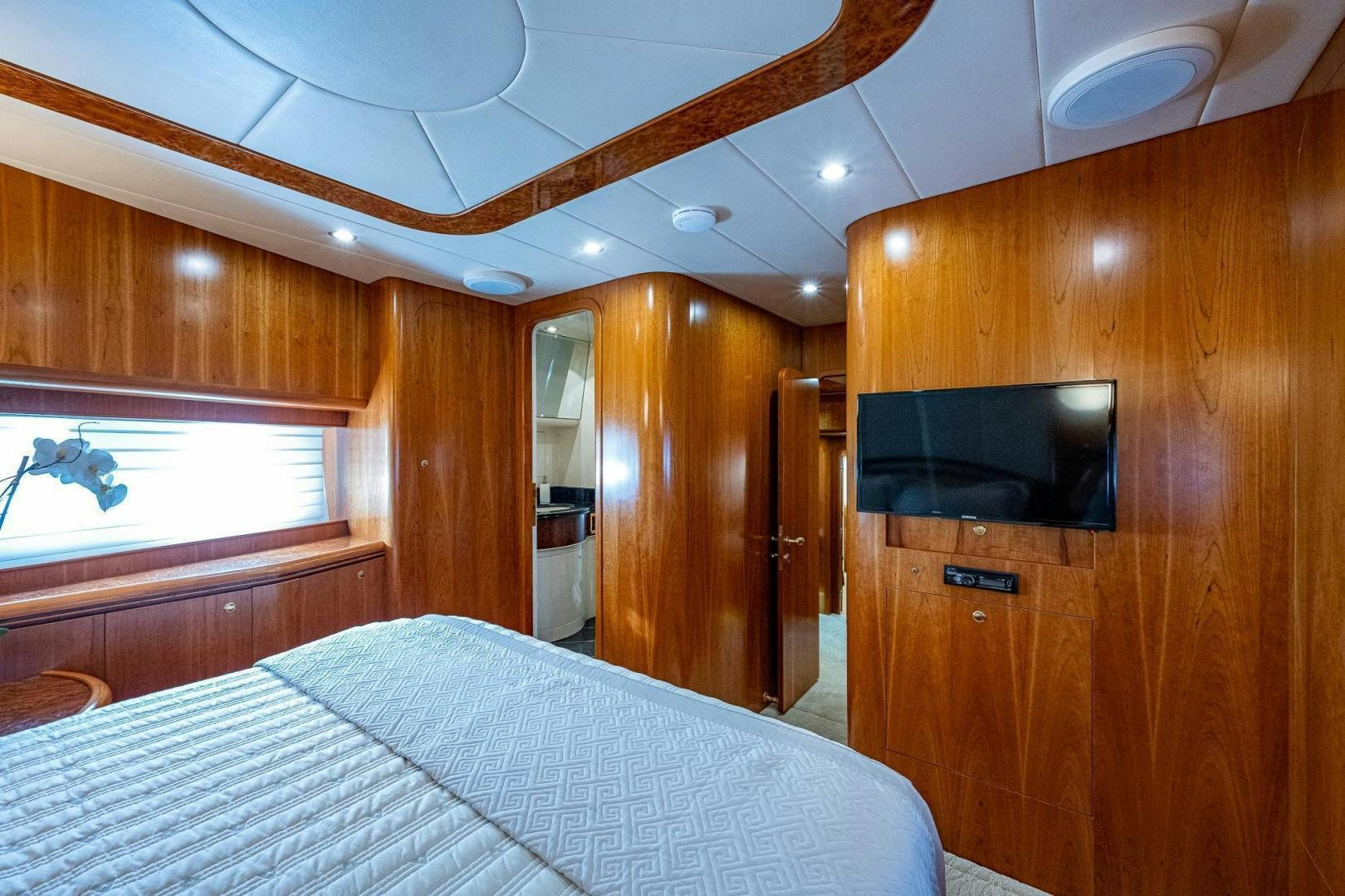 a bedroom with a bed and a television aboard ODYSSEY Yacht for Sale