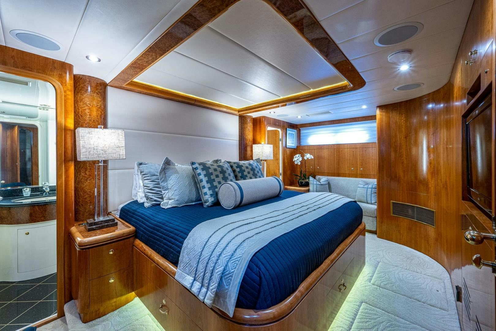 a bedroom with a bed and a mirror aboard ODYSSEY Yacht for Sale
