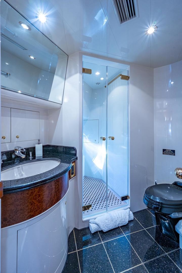 a bathroom with a glass shower aboard ODYSSEY Yacht for Sale