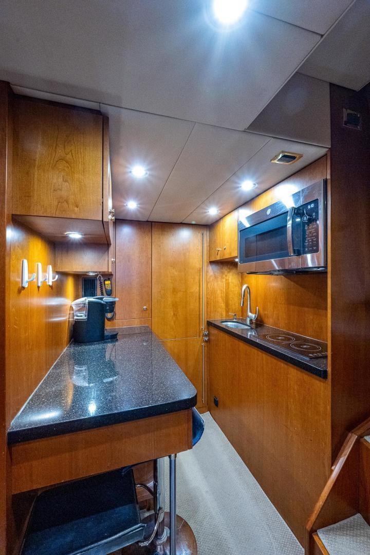 a kitchen with a bar and a microwave aboard ODYSSEY Yacht for Sale
