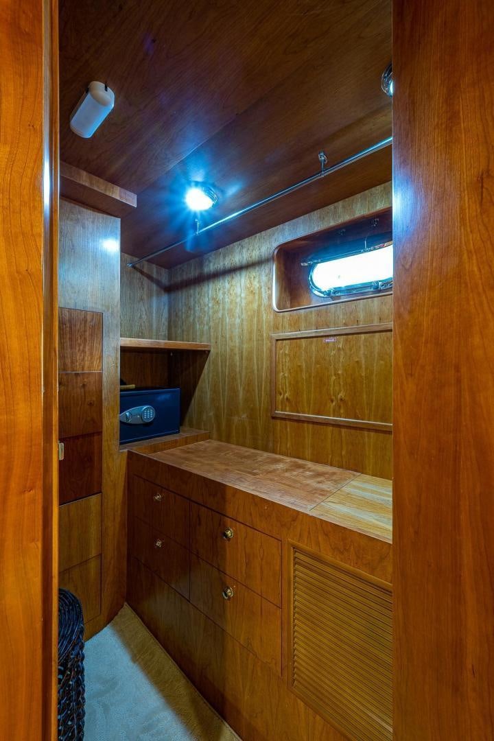 a room with a wood cabinet and a window aboard ODYSSEY Yacht for Sale