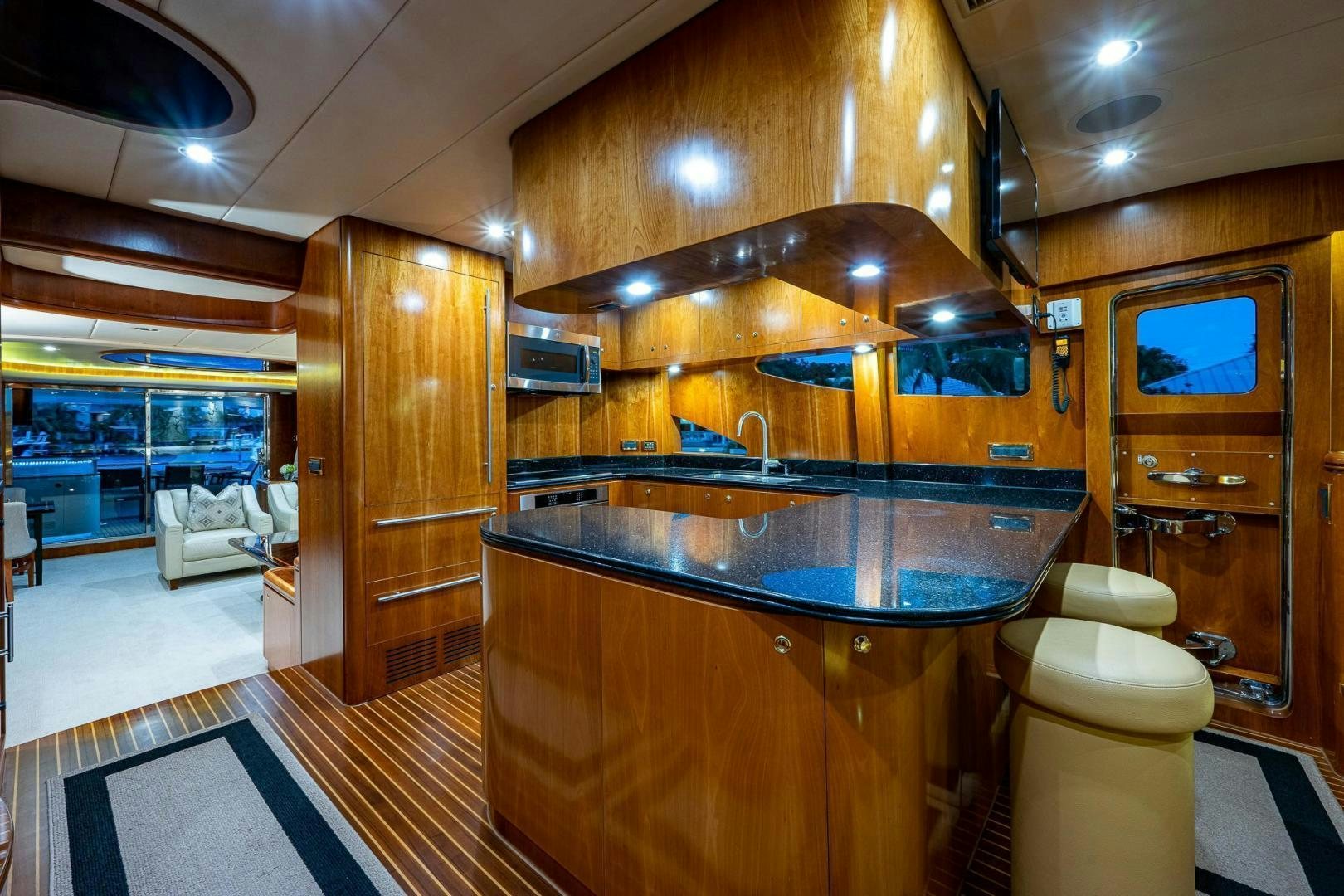 a kitchen with a bar and a fridge aboard ODYSSEY Yacht for Sale