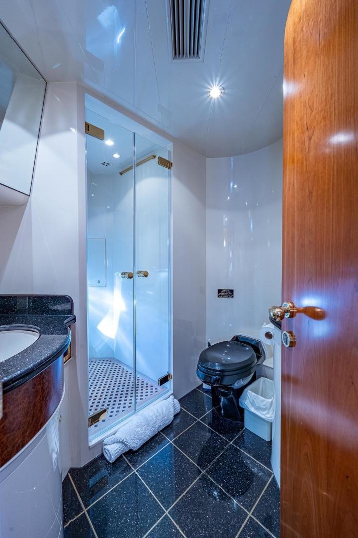a bathroom with a shower and toilet aboard ODYSSEY Yacht for Sale