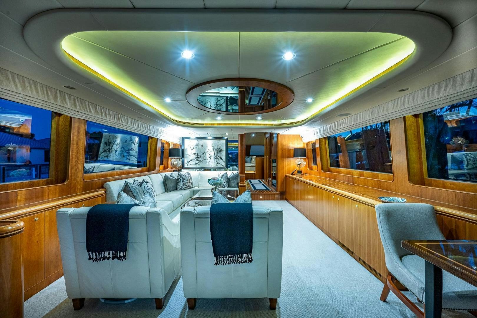 a room with a bed and chairs aboard ODYSSEY Yacht for Sale