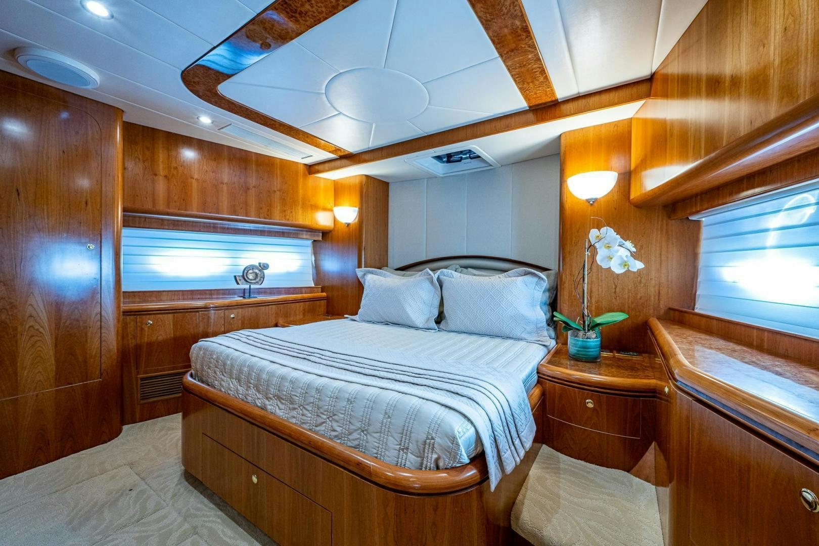 a bedroom with a bed and a window aboard ODYSSEY Yacht for Sale