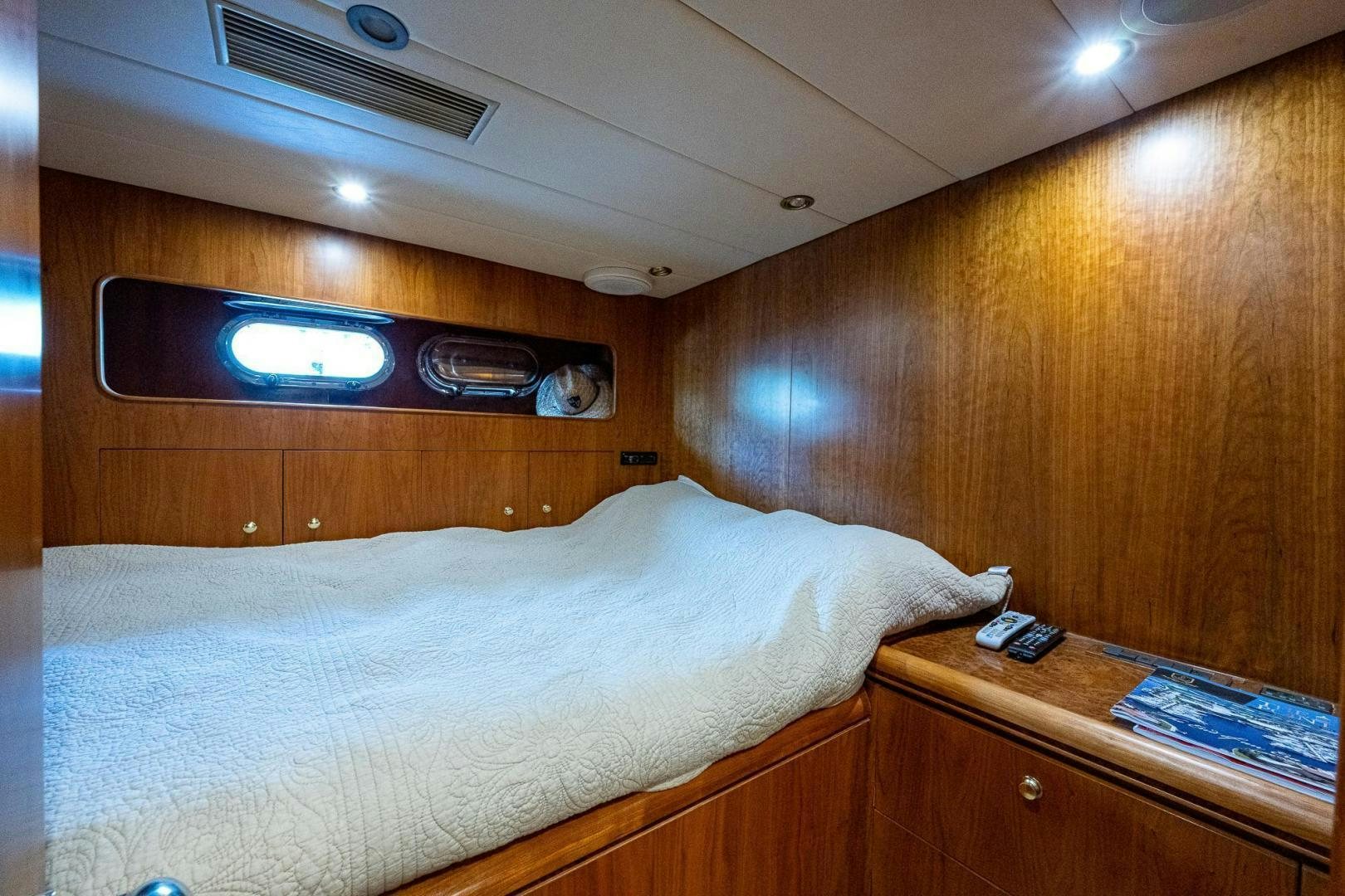 a bed with a television on the wall aboard ODYSSEY Yacht for Sale