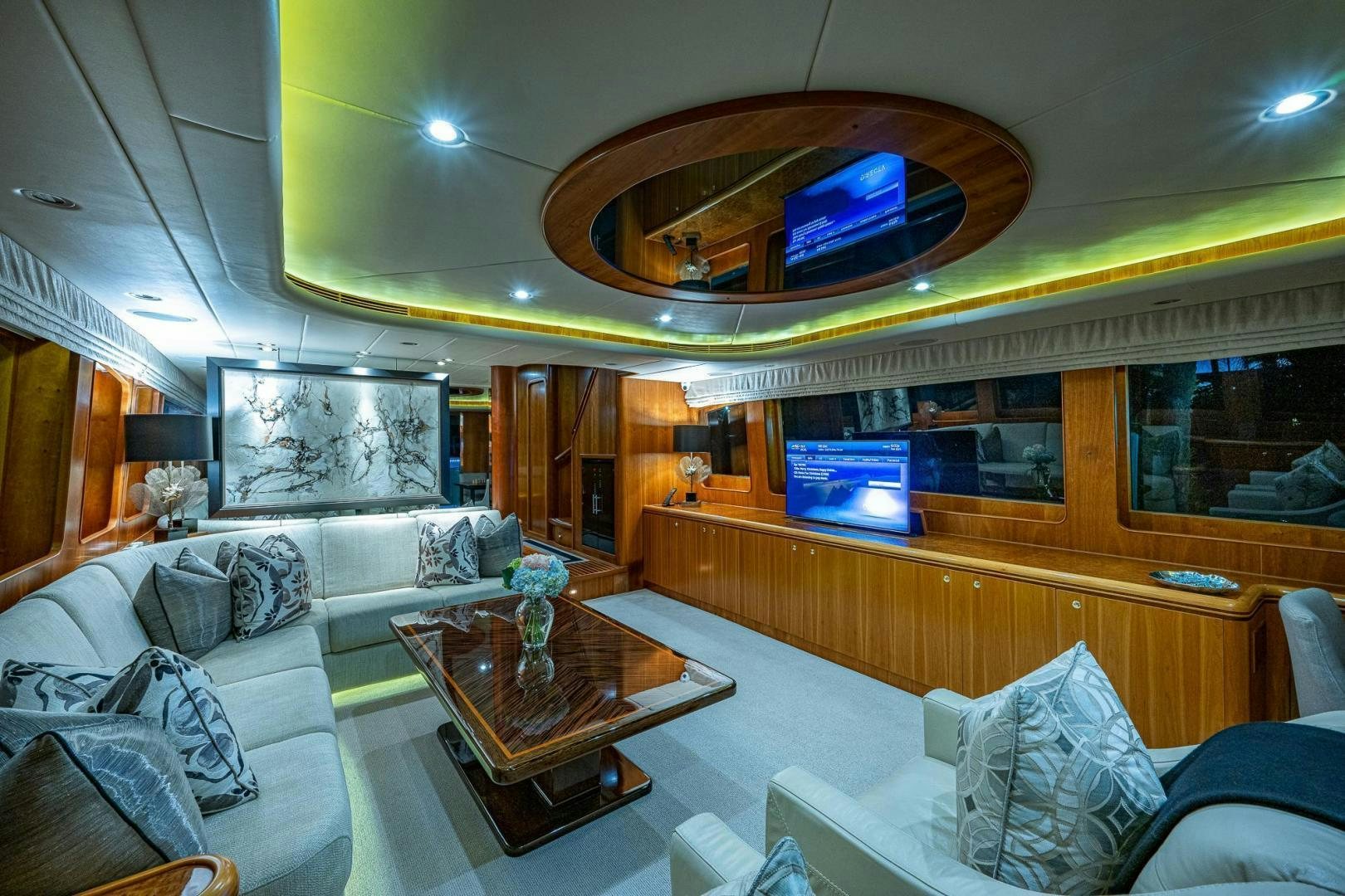 a living room with a large mirror aboard ODYSSEY Yacht for Sale
