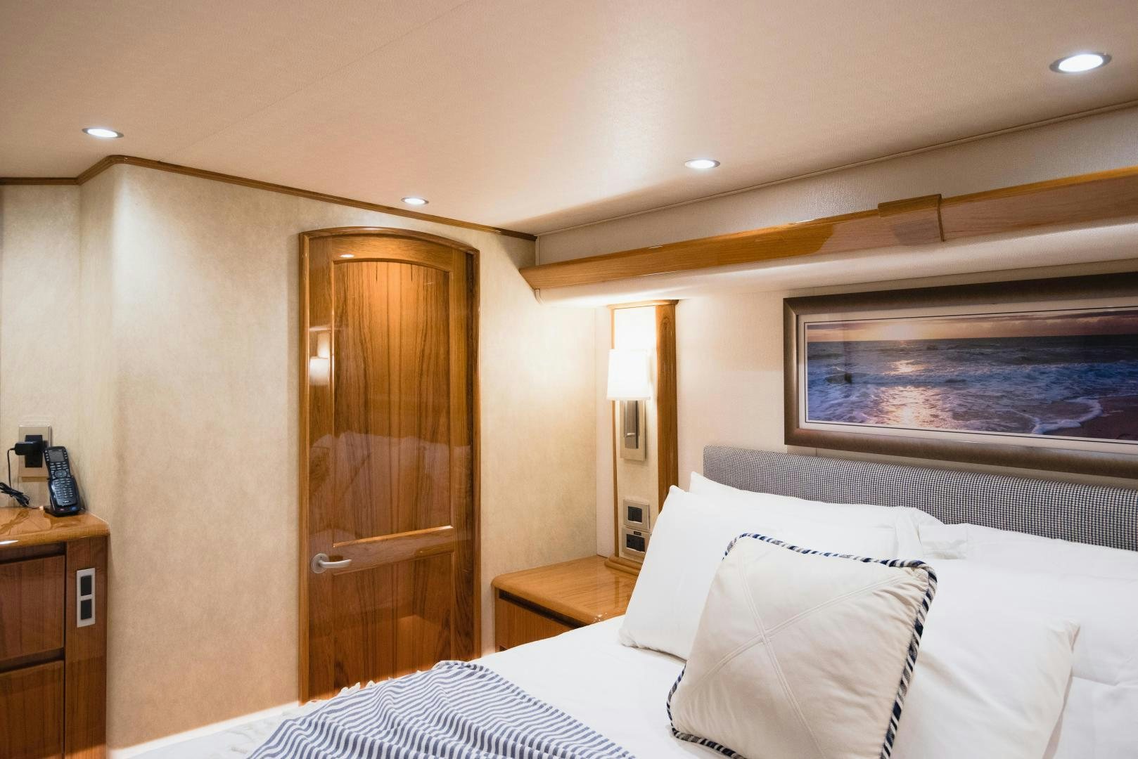 a bedroom with a bed and a wood door aboard C STUDENT Yacht for Sale