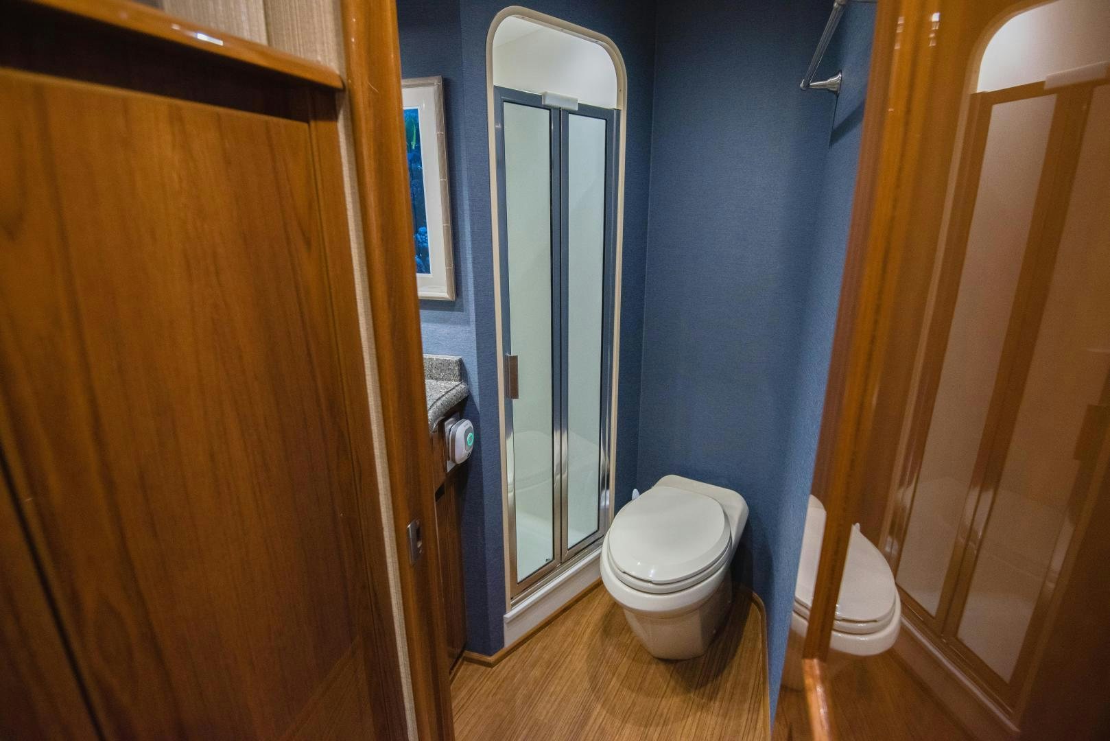 a bathroom with a toilet and a door aboard C STUDENT Yacht for Sale