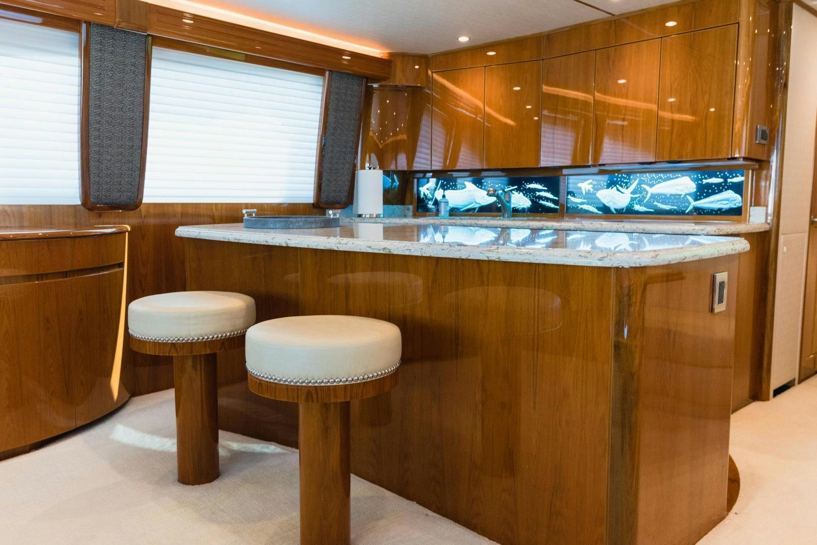 a counter with stools and stools in a room with a window aboard C STUDENT Yacht for Sale