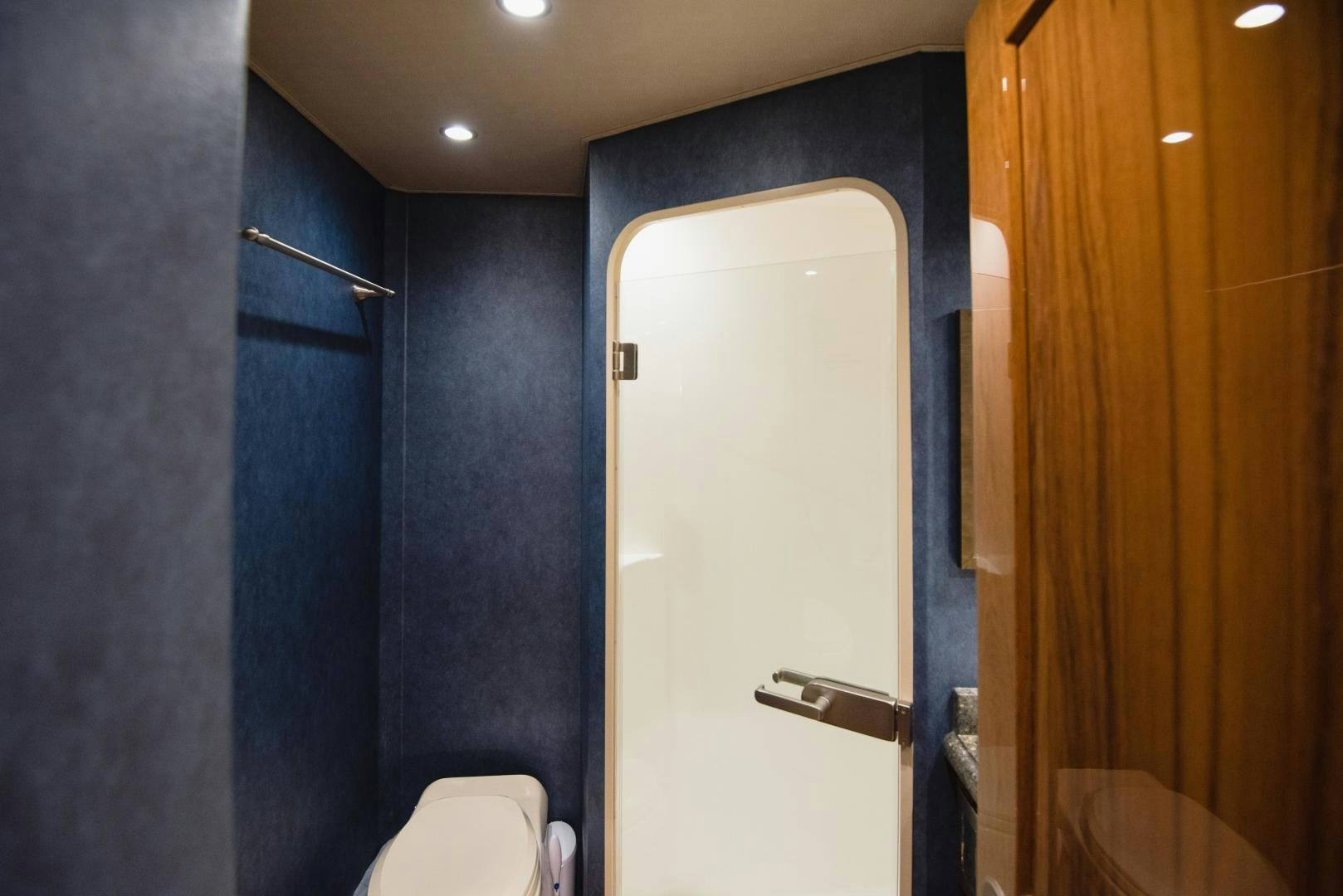 a bathroom with a toilet and a wood door aboard C STUDENT Yacht for Sale